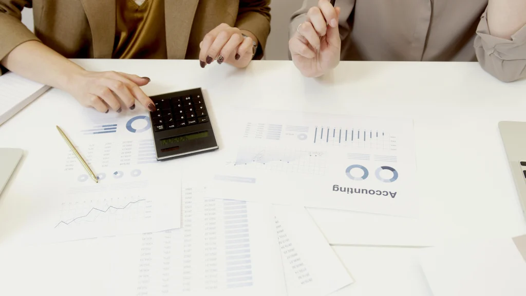 Finance professionals reviewing invoices and accounting reports for outsourced accounts payable services