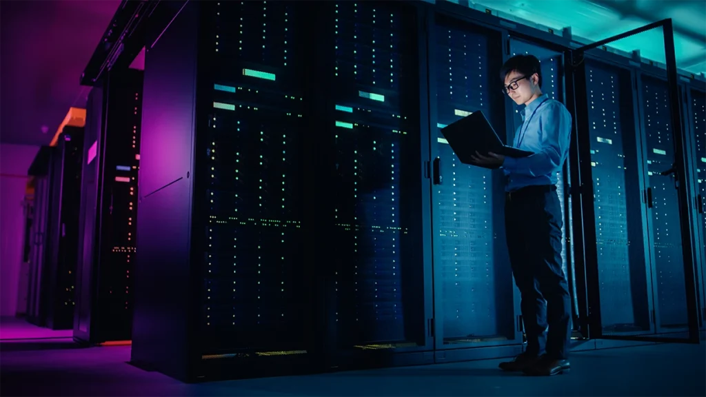 Technical support engineer performing real-time network monitoring and server infrastructure management in a secure data center environment
